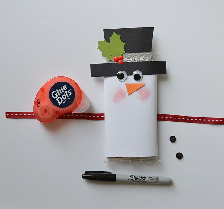 glue-dots-snowman-popcorn-sleeve-adding-face-embellishments.jpg