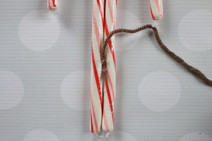 glue-dots-candy-cane-reindeer-wrapping-yarn-around-candy-canes.jpg