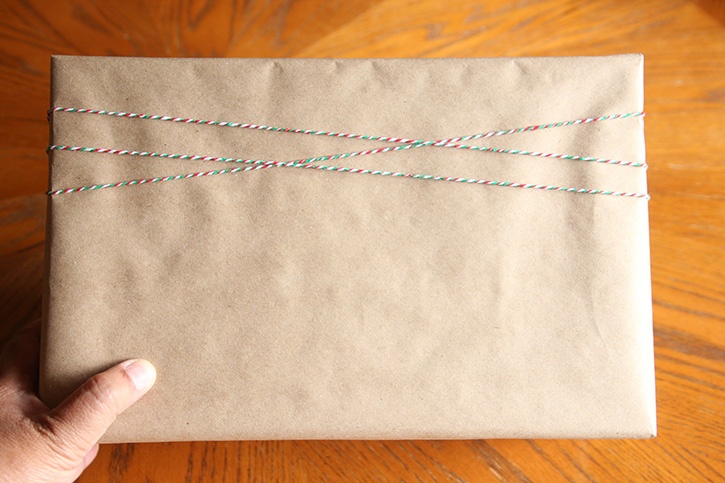 glue-dots-merry-gift-wrap-banner-twine-wrapped-gift.jpg
