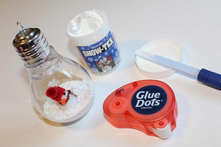glue-dots-lightbulb-ornament-adding-snowtex-dried-snow-and-snowman.jpg